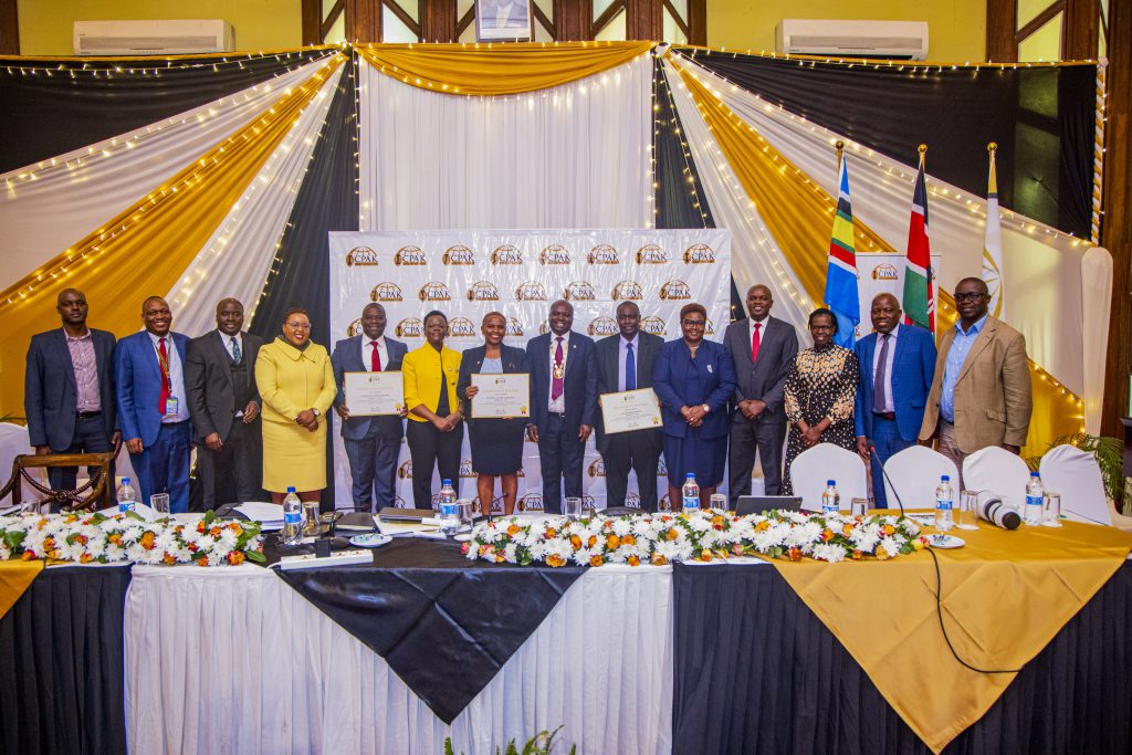 New council member FCPA Benard Amukah, 26th Chairman CPA Prof. Elizabeth Kalunda and New council member CPA Chrispus Mbogo pose for a photo with the council members at the 47th AGM
