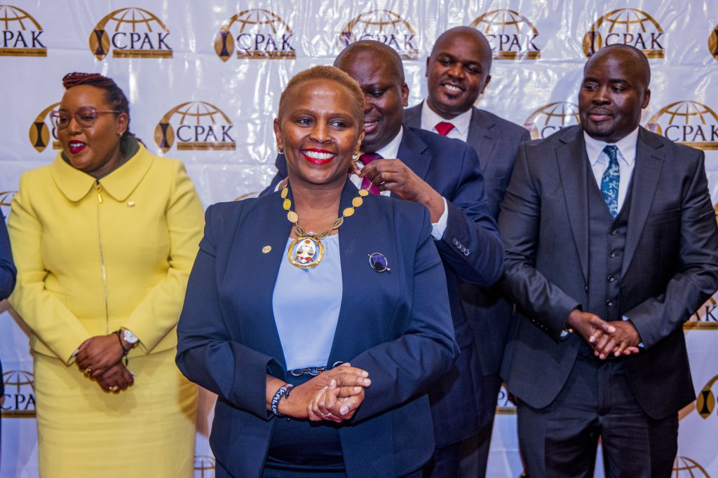 Outgoing ICPAK Chairman CPA Philip Kakai hands over the golden chain to the 26th ICPAK chairman CPA Prof. Elizabeth Kalunda at the 47th AGM