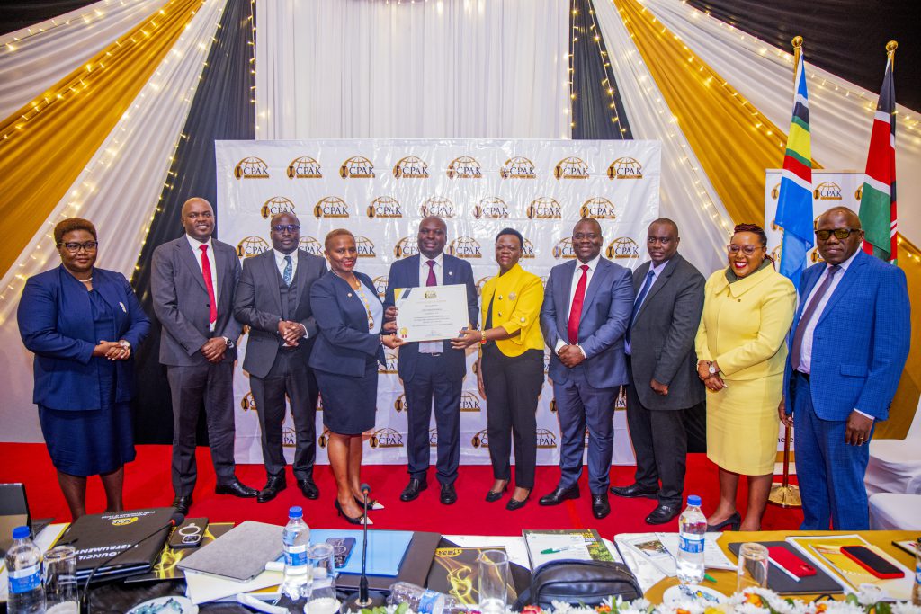 Outgoing ICPAK chairman CPA Philip Kakai receives his certificate of service to the Institute.