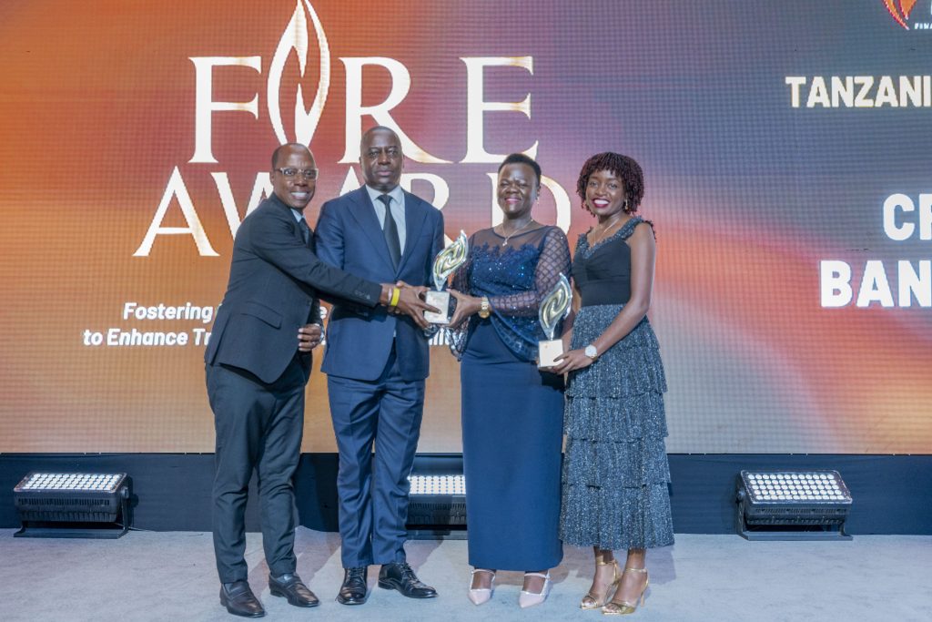 ICPAK CEO CPA Dr. Grace Kamau presents a trophy to CRDB Bank Plc Tanzania during the FiRe Awards
